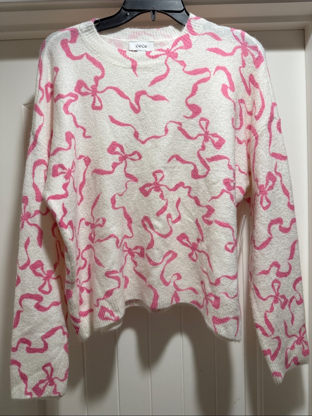 CeCe Cream Crewneck Sweater with Pink Ribbon Motif